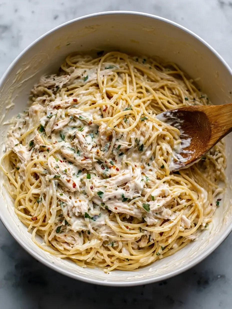 Mixing creamy sauce for Irresistible Spicy Southern Chicken Spaghetti.
