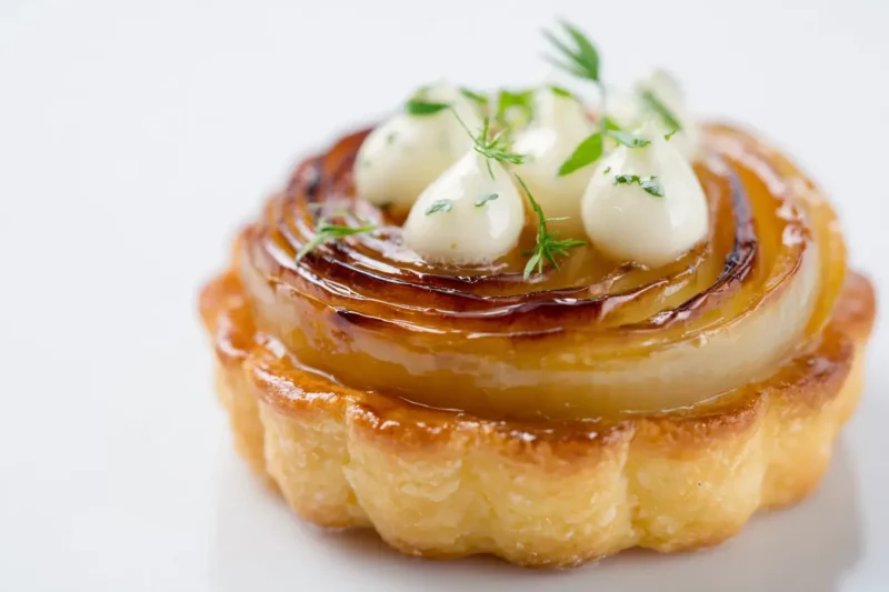 Caramelized onion tartlet with creamy cheese topping